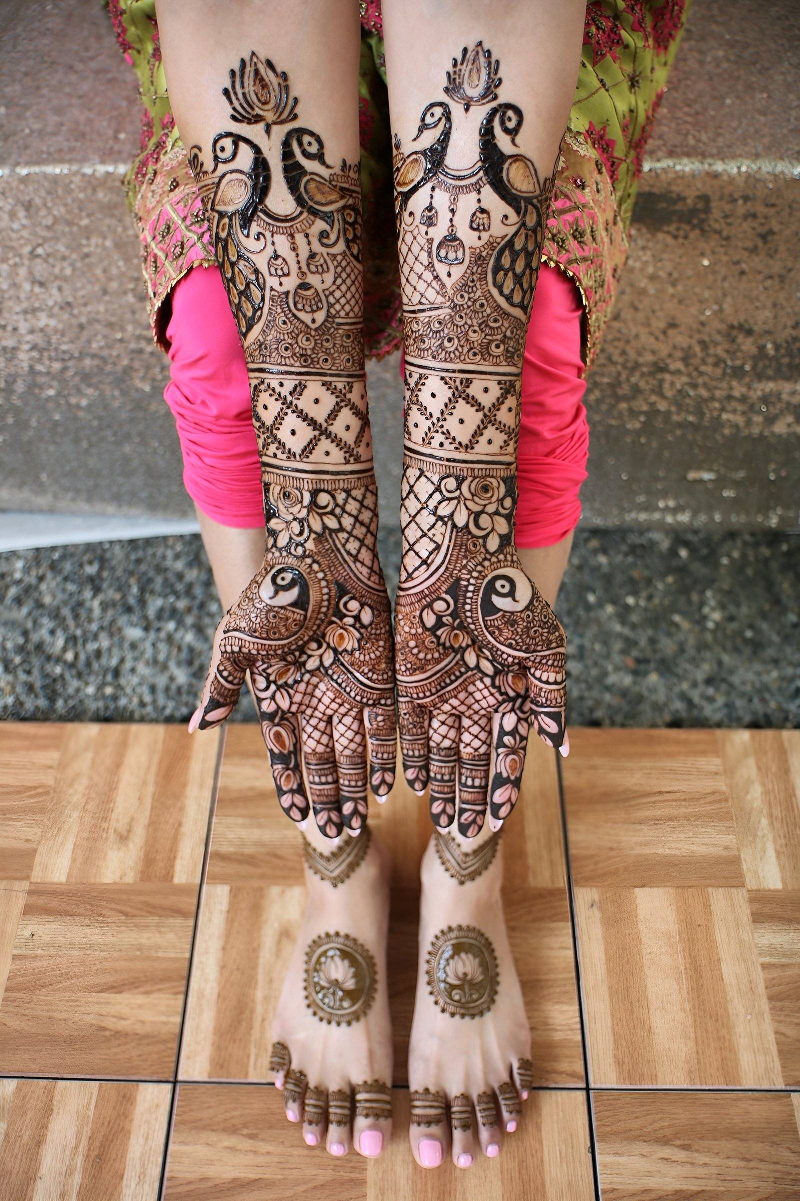 Full bridal henna on arms and feet featuring peacock motifs