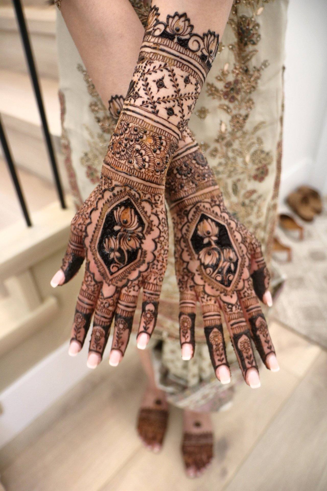 Bride with crossed hands showing intricate henna