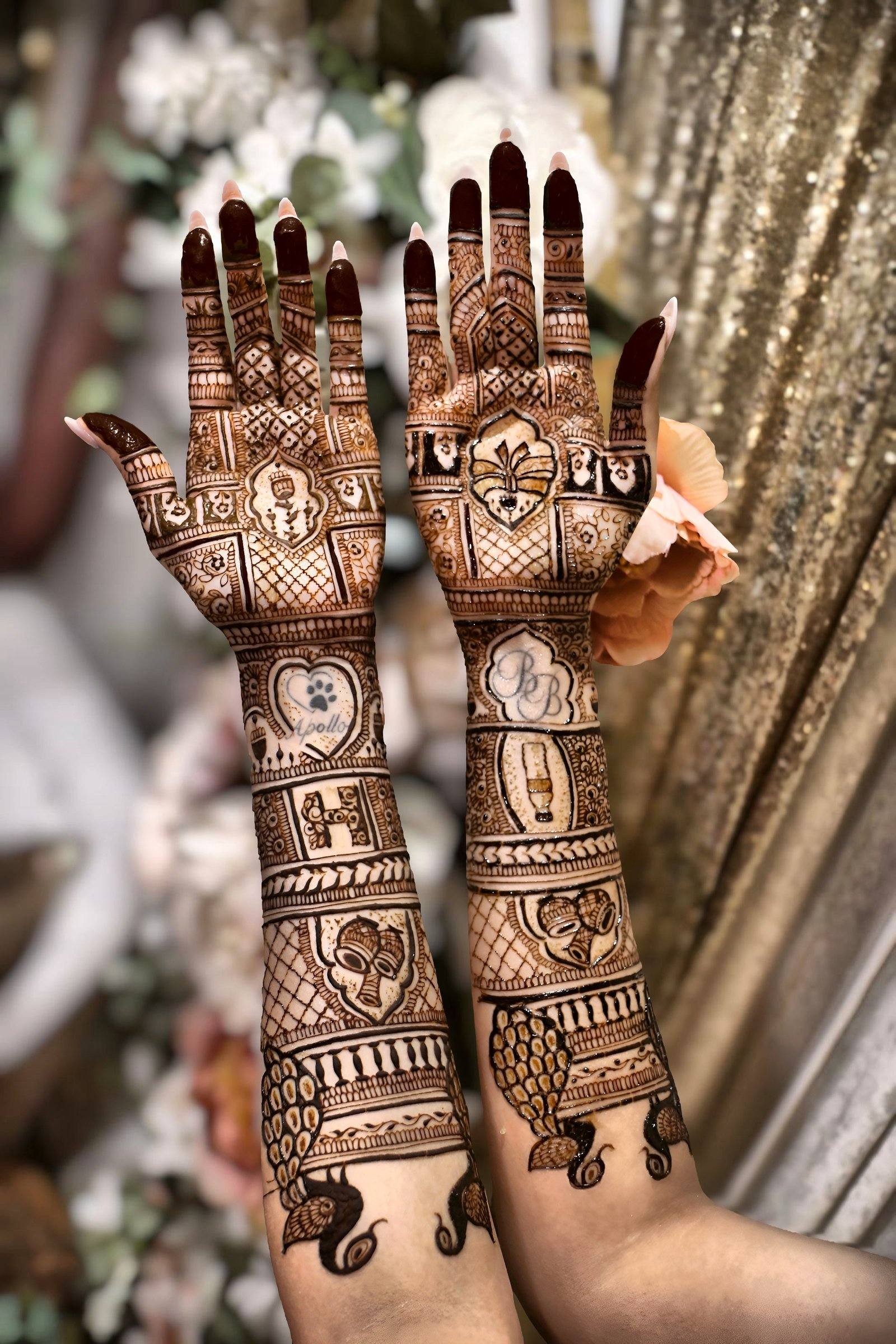 Bridal henna arms with story-panel motifs raised against flowers and gold drapes