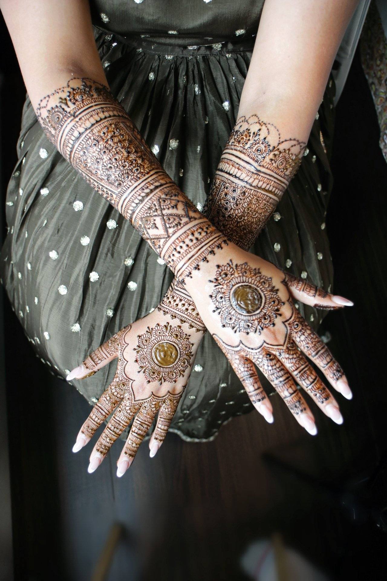 Delicate henna on crossed hands and wrists